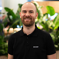 A man with a beard in a black t-shirt
